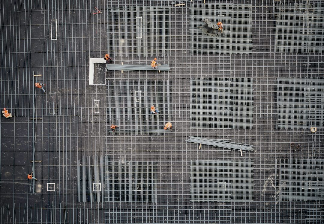 Aerial view of a rebar mat with crews placing steel before a concrete pour