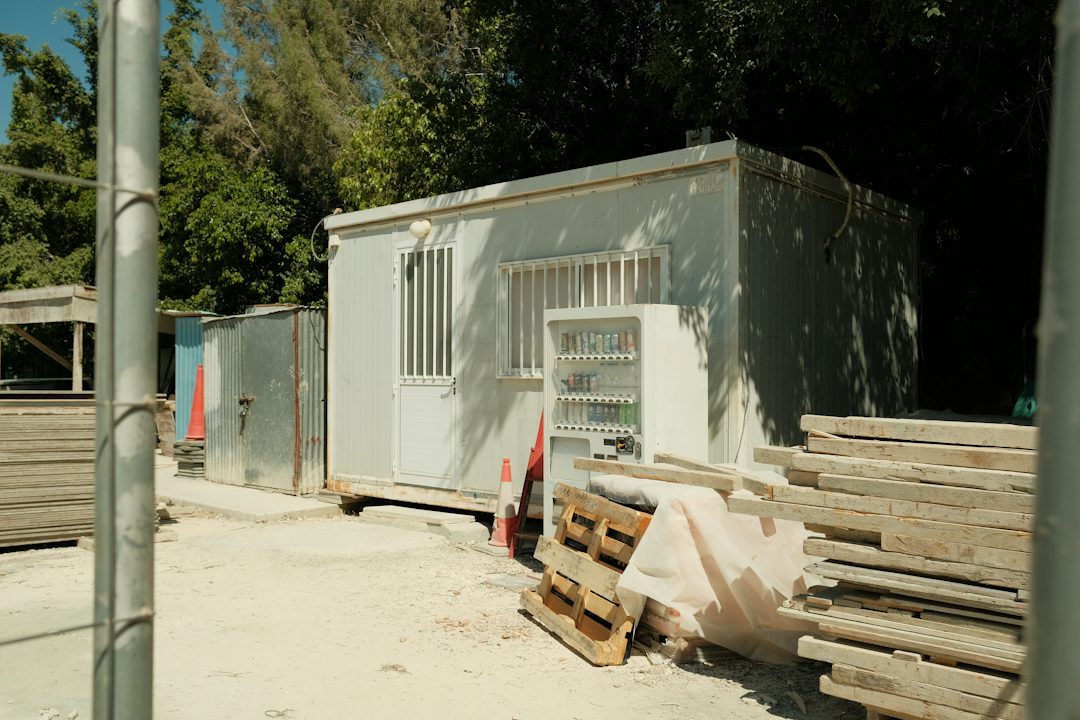 Site office trailer with timber stacked outside